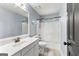 Bathroom featuring single sink vanity with white cabinets, and a shower-tub combo with white tile at 608 Bellenden Dr, Peachtree City, GA 30269