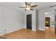 Bedroom features wood laminate flooring, a ceiling fan, and black closet doors at 608 Bellenden Dr, Peachtree City, GA 30269