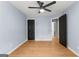 Bedroom featuring wood laminate flooring, light blue walls and black doors at 608 Bellenden Dr, Peachtree City, GA 30269