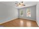 Empty bedroom features wood laminate flooring, ceiling fan, and windows at 608 Bellenden Dr, Peachtree City, GA 30269