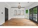Bright dining room featuring built-in shelves, hardwood floors, and a window overlooking the backyard at 608 Bellenden Dr, Peachtree City, GA 30269