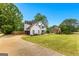 Charming two-story white home with a spacious front yard and a long driveway at 608 Bellenden Dr, Peachtree City, GA 30269