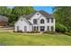 Stunning two-story white home featuring black trim and a beautifully landscaped front yard at 608 Bellenden Dr, Peachtree City, GA 30269