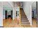 Open foyer with hardwood floors, staircase, and view into the living room with fireplace at 608 Bellenden Dr, Peachtree City, GA 30269