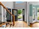 Inviting foyer with hardwood floors, decorative staircase, and view of the front yard at 608 Bellenden Dr, Peachtree City, GA 30269