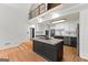 Modern kitchen with white cabinets, black countertops, stainless steel appliances, and a large island at 608 Bellenden Dr, Peachtree City, GA 30269