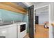 Bright laundry room with modern washer and dryer with plenty of storage space at 608 Bellenden Dr, Peachtree City, GA 30269