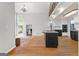 Spacious living room with open layout, hardwood floors, a second-story balcony, and a modern kitchen at 608 Bellenden Dr, Peachtree City, GA 30269