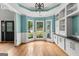 Bright living room with custom built-ins, hardwood floors, and large windows overlooking the yard at 608 Bellenden Dr, Peachtree City, GA 30269