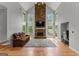 Spacious living room with stone fireplace, large windows, and vaulted ceiling at 608 Bellenden Dr, Peachtree City, GA 30269