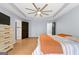 Open main bedroom with trey ceiling, hardwood flooring, and ensuite access at 608 Bellenden Dr, Peachtree City, GA 30269