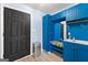 Convenient mudroom with custom blue cabinetry, a sink, and a door leading to the exterior at 608 Bellenden Dr, Peachtree City, GA 30269