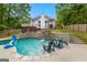 Backyard view of in-ground pool with waterfall feature at 608 Bellenden Dr, Peachtree City, GA 30269