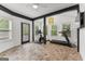 Bright sunroom with exercise equipment, large windows and stylish flooring at 608 Bellenden Dr, Peachtree City, GA 30269