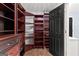 Walk in closet featuring custom wood storage and shelving throughout at 608 Bellenden Dr, Peachtree City, GA 30269