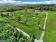 Aerial view of lush green land and forest, showcasing a country estate with a long driveway at 357 Old Driver Rd, Whitesburg, GA 30185