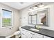 Modern bathroom with a dark countertop, white cabinetry, and contemporary fixtures at 357 Old Driver Rd, Whitesburg, GA 30185