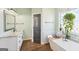Bathroom with a soaking tub with a hanging plant and a white vanity at 357 Old Driver Rd, Whitesburg, GA 30185