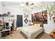 A bedroom features light blue walls, carpet, a bed with wooden frame, and anime decor at 357 Old Driver Rd, Whitesburg, GA 30185
