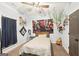 A bright bedroom with light blue walls, neutral carpet, a bed, and a hanging plant for a natural touch at 357 Old Driver Rd, Whitesburg, GA 30185