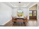 Bright dining area with a large window overlooking the yard, complemented by wood floors at 357 Old Driver Rd, Whitesburg, GA 30185