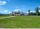 Spacious country estate features a long driveway, green lawn, multiple garages, and white brick at 357 Old Driver Rd, Whitesburg, GA 30185