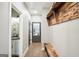 A bright hallway with wood floors, wooden bench, and an adjacent bathroom at 357 Old Driver Rd, Whitesburg, GA 30185