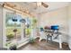Bright home office with wood floors, decorated with green plants, and a large window with a green view at 357 Old Driver Rd, Whitesburg, GA 30185