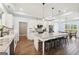 Open-concept kitchen with a central island, stainless steel appliances, and brick accents throughout at 357 Old Driver Rd, Whitesburg, GA 30185