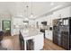Spacious kitchen with stainless steel appliances, white cabinets, brick backsplash, and granite island with seating at 357 Old Driver Rd, Whitesburg, GA 30185