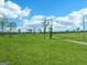 Lush green land dotted with trees under a sunny sky, showcasing a peaceful, natural setting at 357 Old Driver Rd, Whitesburg, GA 30185