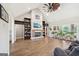 Inviting living room featuring a ceiling fan, fireplace, built-in bookshelves, and ample natural light at 357 Old Driver Rd, Whitesburg, GA 30185