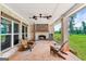 Covered brick patio with a fireplace and seating overlooking the backyard at 357 Old Driver Rd, Whitesburg, GA 30185