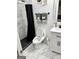 Bathroom with black fixtures, marble floors, neutral paint, shower with black curtain and towel rack at 441 Lilywood Dr, Mcdonough, GA 30253
