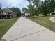 Long driveway leading to a beautiful home, showcasing curb appeal at 441 Lilywood Dr, Mcdonough, GA 30253