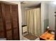 Modest bathroom with neutral colored shower curtain and wood vanity at 5780 Hill Rd, Powder Springs, GA 30127