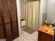 Modest bathroom with neutral colored shower curtain and wood vanity at 5780 Hill Rd, Powder Springs, GA 30127