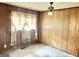 Bedroom with paneled walls, ceiling fan and large window at 5780 Hill Rd, Powder Springs, GA 30127