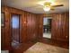Living room with wood paneling and a ceiling fan at 5780 Hill Rd, Powder Springs, GA 30127