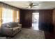 Living room with wood paneling and a ceiling fan at 5780 Hill Rd, Powder Springs, GA 30127