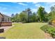Beautiful backyard with stone patio, hot tub, and lush landscaping, perfect for outdoor entertaining at 266 Blue Point Pkwy, Fayetteville, GA 30215