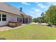 Backyard area boasting a stone patio, hot tub, and screened-in porch for relaxing and entertaining at 266 Blue Point Pkwy, Fayetteville, GA 30215