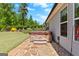 Stone patio with a hot tub, offering a private and relaxing outdoor space amidst lush greenery at 266 Blue Point Pkwy, Fayetteville, GA 30215