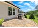 Stone patio area featuring a grill, perfect for outdoor cooking and entertaining with scenic backyard views at 266 Blue Point Pkwy, Fayetteville, GA 30215