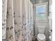 Clean bathroom featuring a toilet and shower with decorative curtain at 266 Blue Point Pkwy, Fayetteville, GA 30215