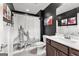 Modern bathroom boasting black walls, Tower Bridge and Telephone Booth decor, and white wainscoting and granite vanity at 266 Blue Point Pkwy, Fayetteville, GA 30215