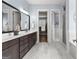Bathroom with marble floors, a dark vanity, and an open doorway to the water closet and walk-in closet at 266 Blue Point Pkwy, Fayetteville, GA 30215