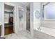 Bathroom featuring a marble-surround tub, marble floors, shower, and open doorway to the walk-in closet at 266 Blue Point Pkwy, Fayetteville, GA 30215