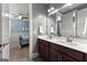 Spacious bathroom with double sink vanity and dark wood cabinets and views of the bedroom at 266 Blue Point Pkwy, Fayetteville, GA 30215