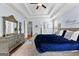 A bedroom suite featuring a decorative ceiling, a large bed with a blue coverlet, and a grey dresser at 266 Blue Point Pkwy, Fayetteville, GA 30215